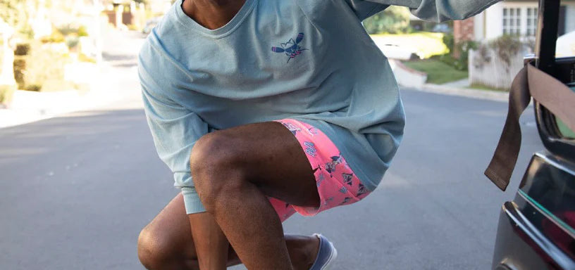 man riding a skateboard wearing the pink hammertime shorts