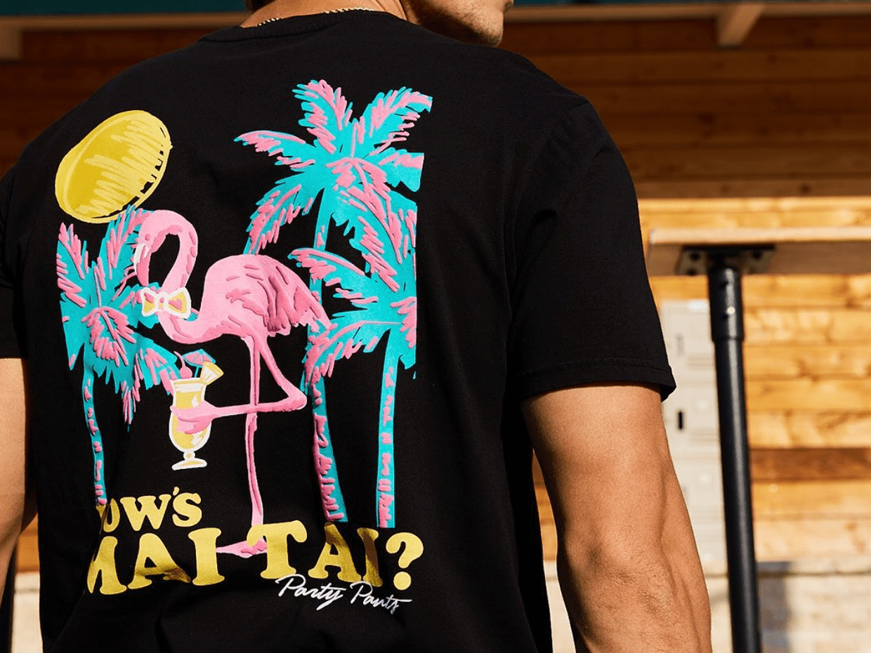 man wearing a black neon mai tai t-shirt
