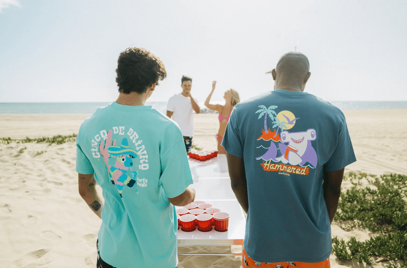 A group of friends playing beer bong