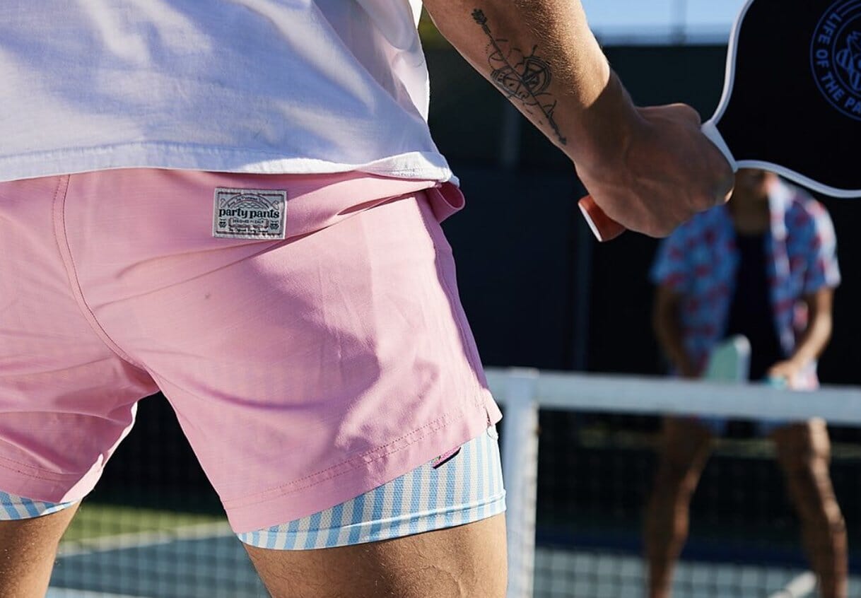 man wearing pink solid color with blue and white striped lining