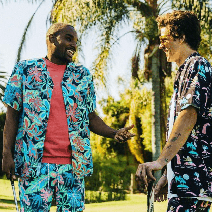 Two guys wearing men’s print button-down shirts at a golf course