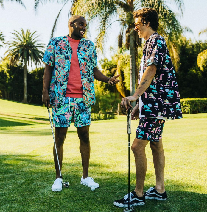 Two guys wearing cabana sets at a golf course