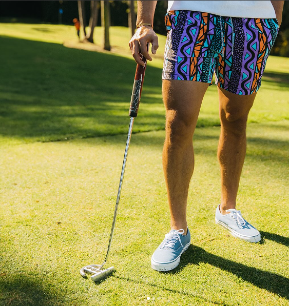 A guy wearing the Maui Wowie Party Starter Short on a golf course