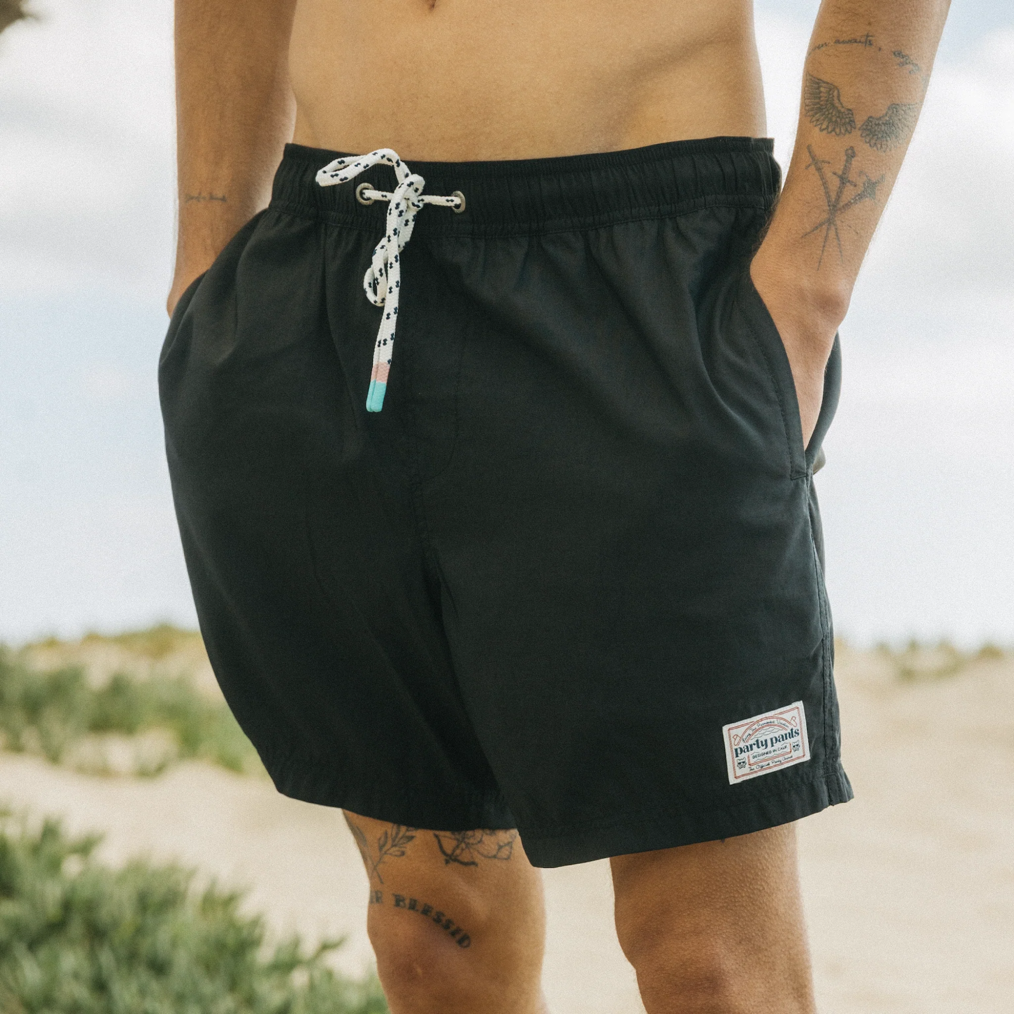 A guy wearing the Nylon Party Short in black