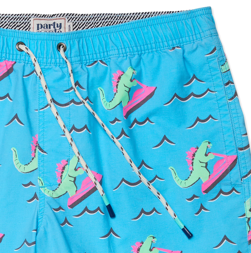 A pair of Party Pants stretch swim shorts with dinosaurs on jet skis